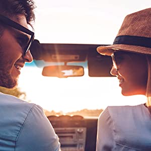 Attractive couple driving off into the sunset in their open top sports car