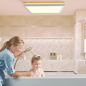 Mom bathing kid in large tub beautiful bathroom