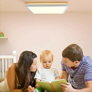 Parents reading book with son in nursery room