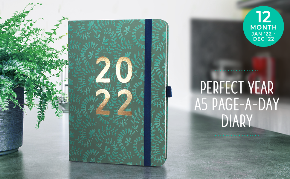 The 2022 Perfect Year A5 Page-A-Day Diary stood on a worktop next to a potted plant.