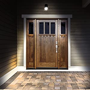 bright spotlight illuminating the doorway of a darkened house at night