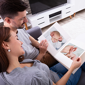 couple looking at baby photo album